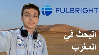 Video still: Reese in the Moroccan desert, titled in Arabic “Research in Morocco”, with the Fulbright logo